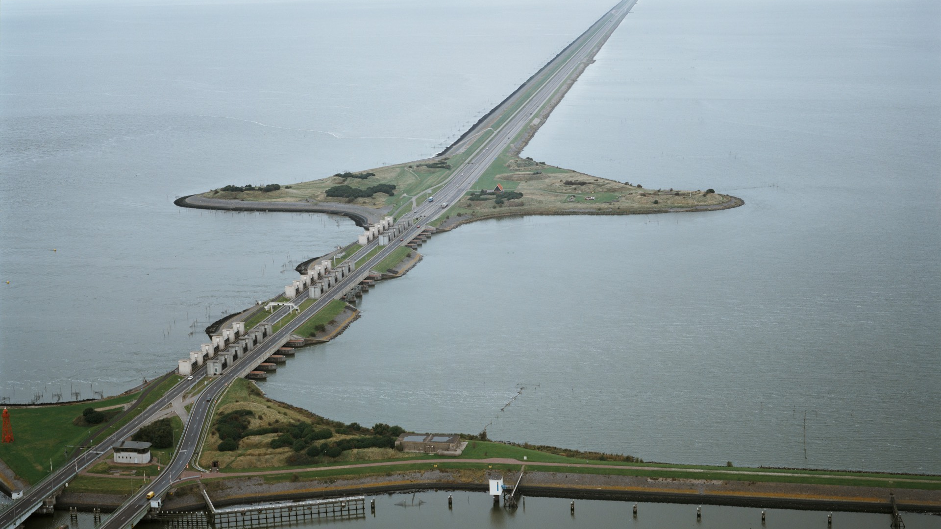 Luchtfoto waarop een deel van de afsluitdijk zichtbaar is met aan beide zijden water.